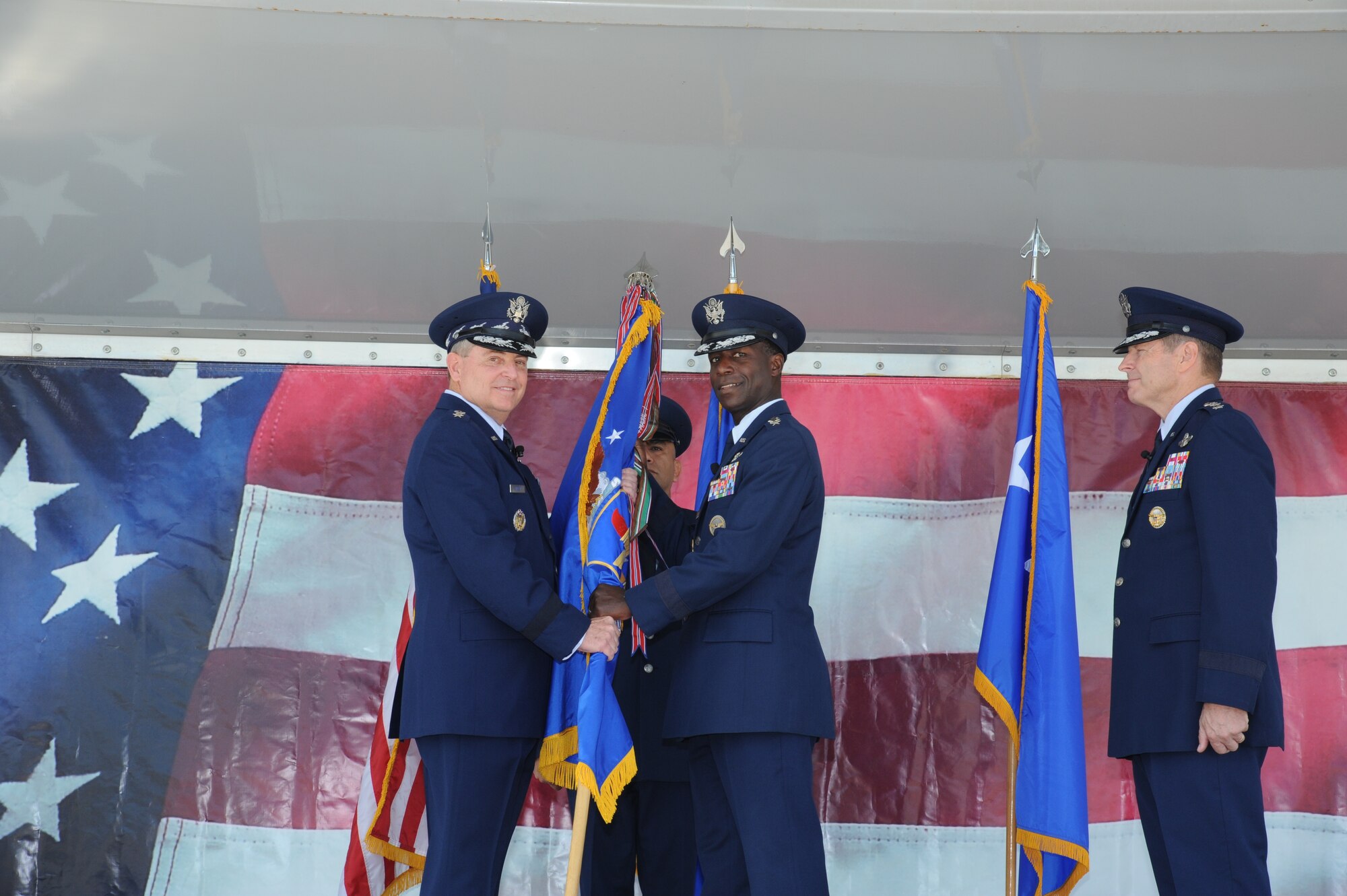 JOINT BASE SAN ANTONIO-RANDOLPH, Texas -- Air Force Chief of Staff Gen. Mark A. Welsh III (left) retrieves the Air Education and Training Command flag from Gen. Edward A. Rice Jr. during a change of command ceremony here Oct. 10, officially relinquishing command. Gen. Robin Rand (right) stands by to assume command of AETC. (U.S. Air Force photo by Rich McFadden)