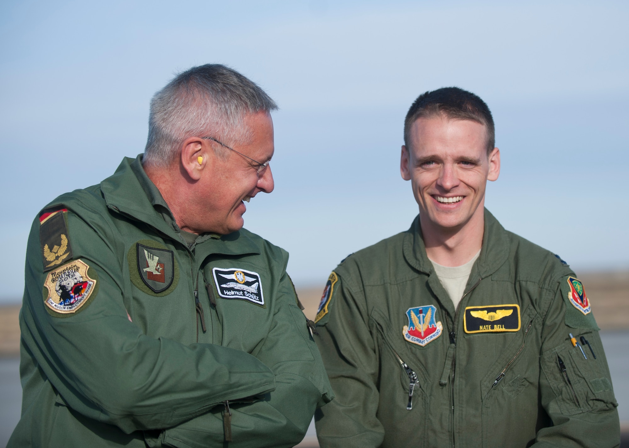 German Air Force Brig. Gen. Helmut Schütz (left), GAF Operational Forces Command commander, and U.S. Air Force Capt. Nate Bell, 391st Fighter Squadron executive officer, laugh during a conversation Oct. 9, 2013, at Mountain Home Air Force Base, Idaho. Schütz and other distinguished were able to watch the air craft take-off during the 2013 Mountain Roundup training exercise. (U.S. Air Force photo by Airman 1st Class Brittany A. Chase/Released)