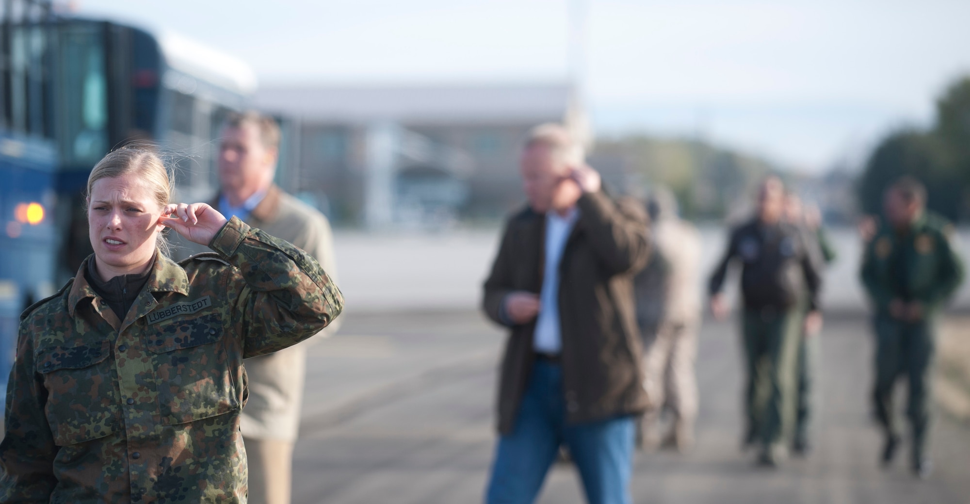 German Air Force 1st Lt. Sabine Lübberstedt places an ear plug in her ear Oct. 9, 2013, at Mountain Home Air Force Base, Idaho. Lübberstedt, along with other distinguished visitors, came to see the GAF's involvement and capabilities they're bringing to the 2013 Mountain Roundup training exercise. (U.S. Air Force photo by Airman 1st Class Brittany A. Chase/Released)