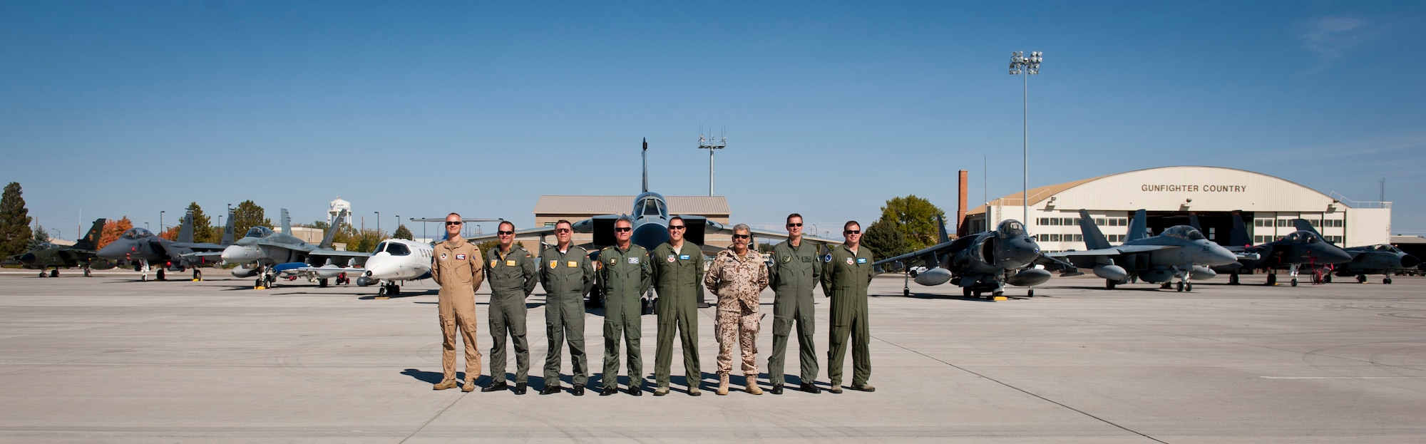 Distinguish visitors pose in front of an aircraft display Oct. 9, 2013, at Mountain Home Air Force Base, Idaho. German, Canadian and U.S. aircraft flew into MHAFB Sep. 30 to take part in the multinational and multi-service exercise better known as Mountain Roundup. (U.S. Air Force photo by Airman 1st Class Brittany A. Chase/Released)