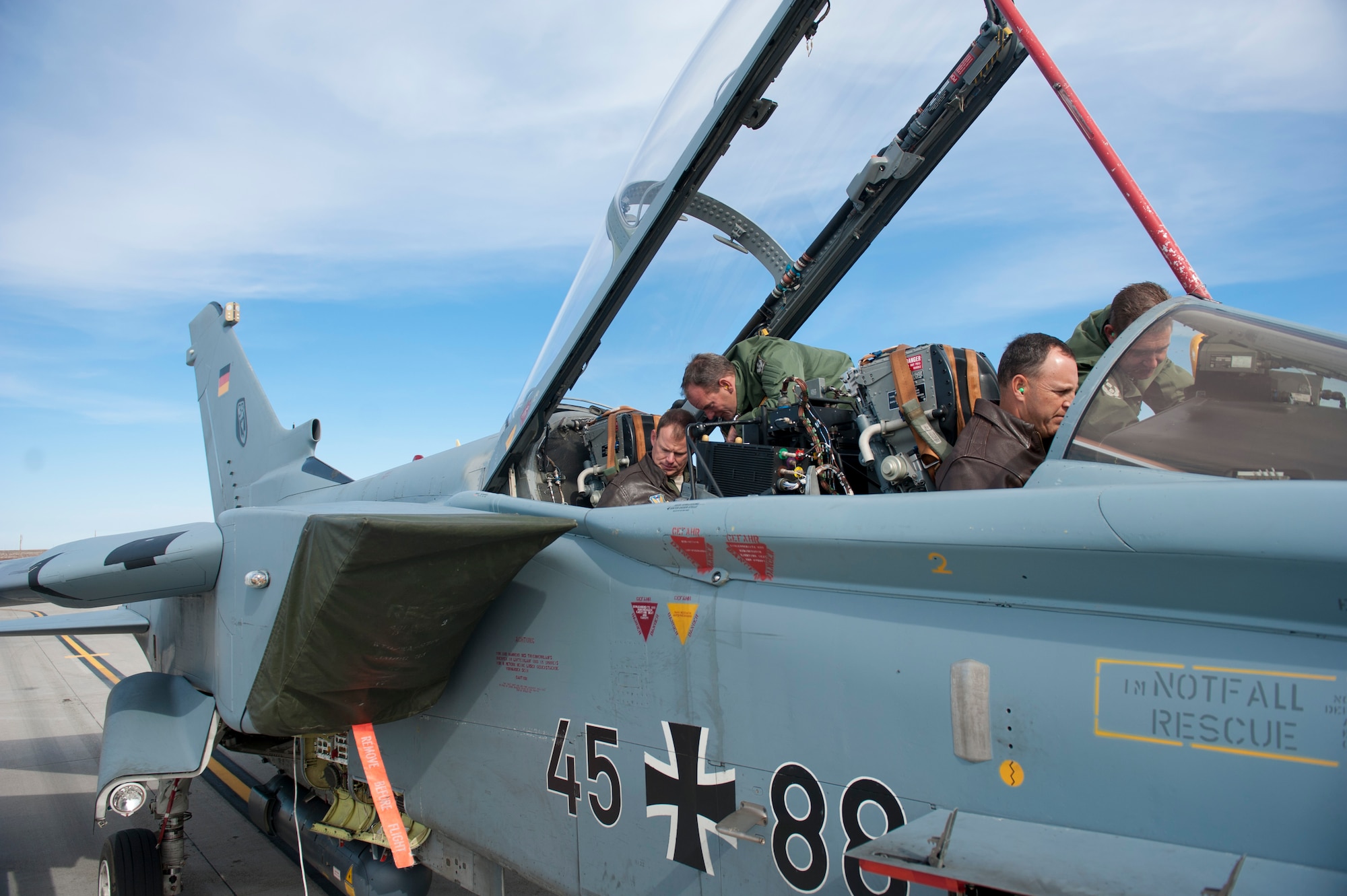 U.S. Air Force Col. Chris Short, 366th Fighter Wing commander, and Col. Ron Anderson, 366th FW vice commander, are shown the cockpit of a German Air Force AG-51 Tornado by two German Air Force members Oct. 9, 2013, at Mountain Home Air Force Base, Idaho. A major goal of Mountain Roundup, a large-scale international exercise, is to help service members from different branches and countries become more familiar with the tactics and equipment of their allies. (U.S. Air Force photo by Airman 1st Class Brittany A. Chase/Released)