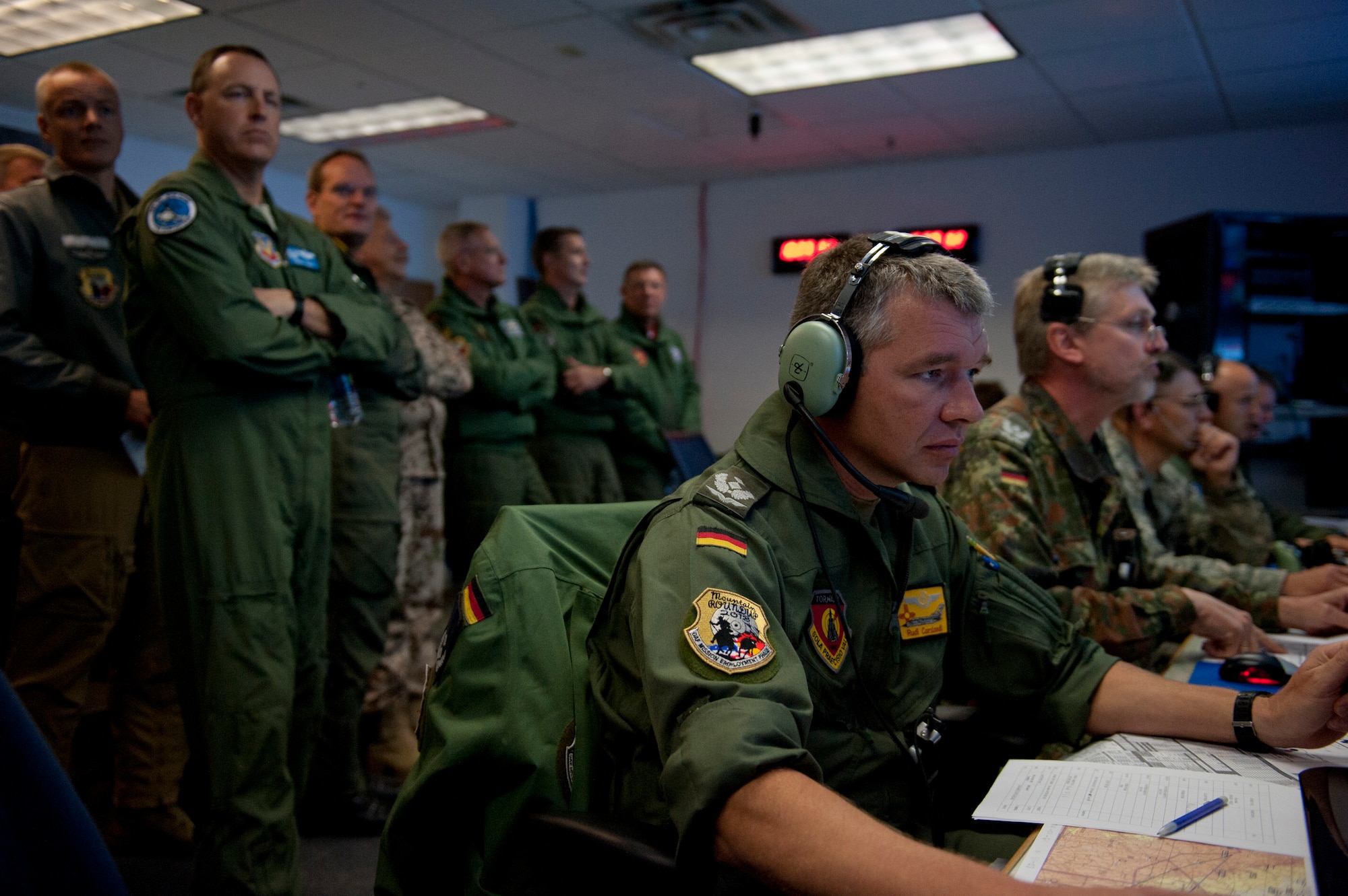 Distinguished visitors watch the operations of Cowboy Control Oct. 9, 2013, at Mountain Home Air Force Base, Idaho. The air crew communicated with pilots to help them stay clear of simulated enemy aircraft during a sortie in the 2013 Mountain Roundup training exercise. (U.S. Air Force photo by Airman 1st Class Brittany A. Chase/Released)