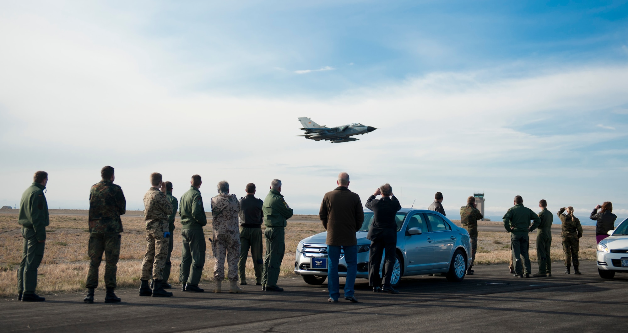 Distinguished visitors watch a German Air Force AG-51 Tornado take-off from the flight line Oct. 9, 2013, at Mountain Home Air Force Base, Idaho. The Tornado went on a training sortie along with multiple other air craft from Germany, Canada and the U.S. during the 2013 Mountain Roundup training exercise. (U.S. Air Force photo by Airman 1st Class Brittany A. Chase/Released)