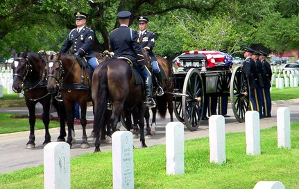 Soldiers with the first Caisson Section carry the flag-draped remains of a military member accompanied by the Military Honors Platoon to the final resting place at the Fort Sam Houston National Cemetery. (Courtesy of the JBSA-Fort Sam Houston Caisson Section)