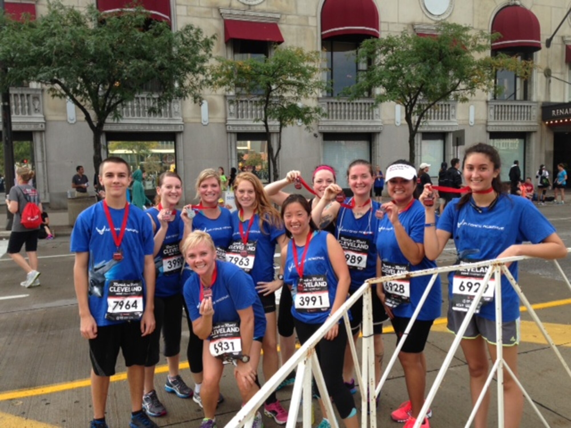CLEVELAND, Ohio--910th Airlift Wing Airmen and family members pose with their medals after running a 3.5 mile race at the inaugural Rock 'n' Roll Cleveland Half Marathon, Sunday, Oct. 6. The Service members were scheduled for a Unit Training Assembly (UTA) the weekend of Oct. 5-6, until the partial government shutdown began, forcing a UTA reschedule. The Airmen decided to use the time in a positive, morale boosting way, while promoting Fit to Fight, the Air Force physical fitness test. The event attracted thousands of runners for the mini marathon and half marathon. 