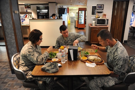 Airmen 1st Class Karen Leal, 359th Aerospace Medicine Squadron, Kevin Failla, 902nd Comptroller Squadron, and Andres Gomez, 359th AMDS, have lunch Sept. 26 at the Joint Base San Antonio-Randolph Rendezvous Dining Facility.  (U.S. Air Force photo by Joel Martinez)