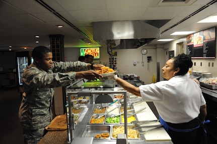 Alene Cooper (right) serves Airman Rashawn Williams Sept. 26 at the Joint Base San Antonio-Randolph Rendezvous Dining Facility. (U.S. Air Force photo by Joel Martinez)