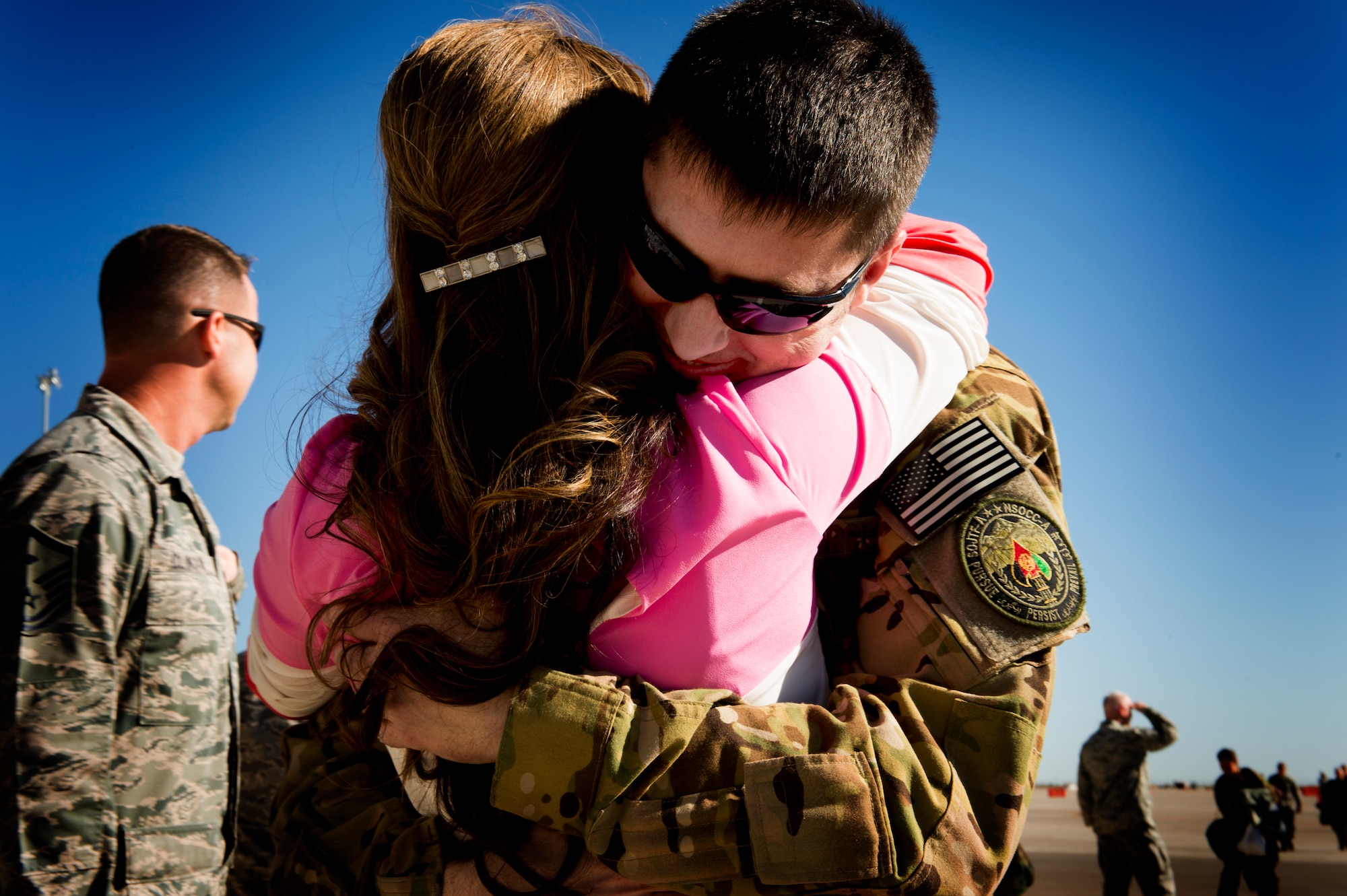 U.S. Air Force Major Robert Bingham embraces his wife Elssy upon his arrival home at Cannon Air Force Base, N.M. Oct. 7, 2013. Bingham's return marked the end of a four-month long deployment away from his family to Afghanistan. (U.S. Air Force photo/ Staff Sgt. Matthew Plew)(RELEASED)
  