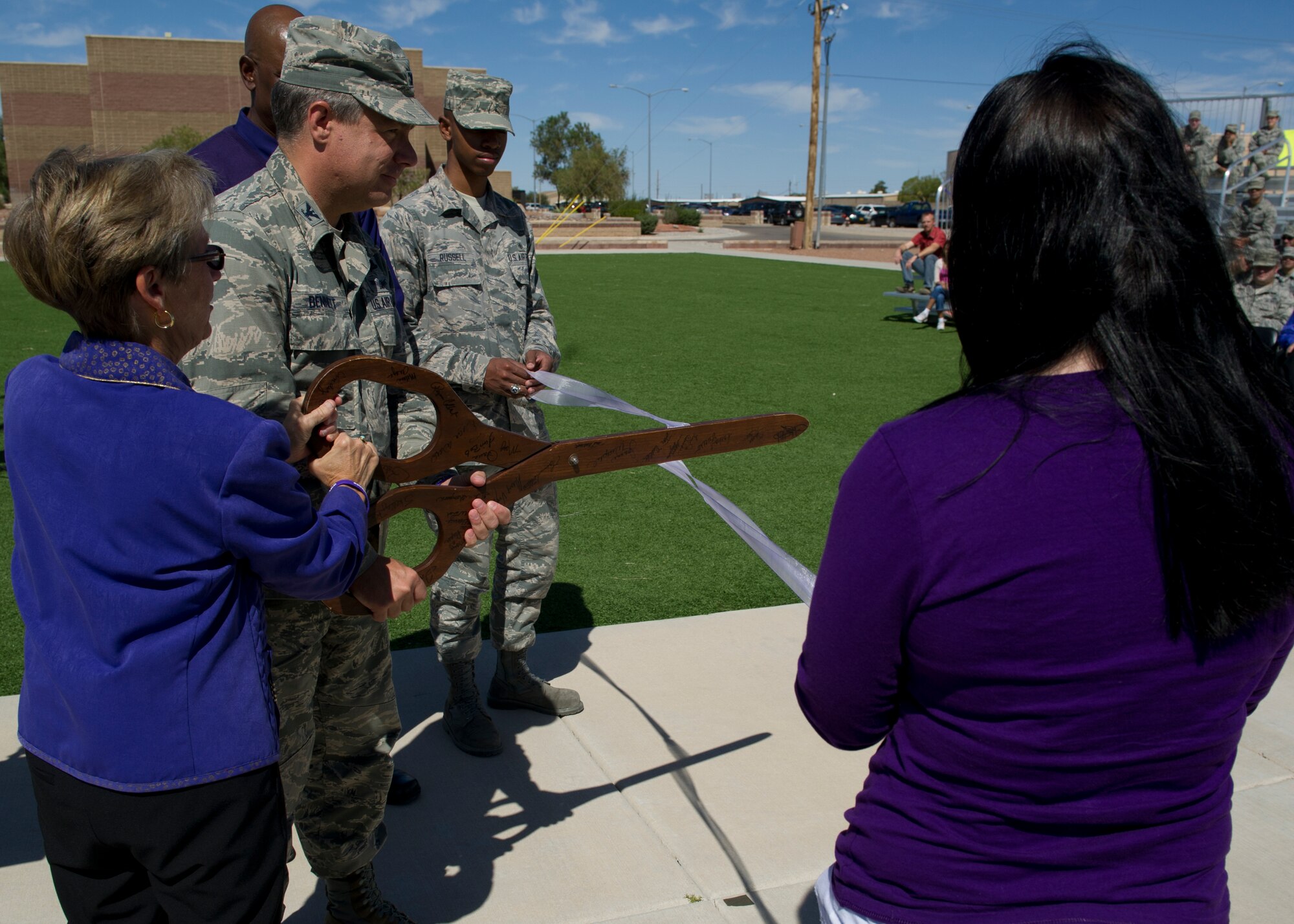 Col. Kevin Bennett, 49th Mission Support Group commander, and Kay Gomolak, Center of Protective Environment executive director cut a purple ribbon, representing  Domestic Violence Awareness Month at Heritage Park at Holloman Air Force Base, N.M., Oct 8. The Family Advocacy Program is sponsoring activities throughout the month of October to promote domestic violence awareness month. (U.S. Air Force Photo by Airman 1st Class Chase Cannon/Released)