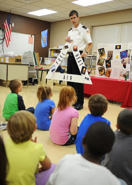 Bill Beck, 28th Civil Engineer Squadron fire inspector, speaks about fire prevention with kindergarten students at Badger Clark Elementary School in Box Elder, S.D. Oct. 3, 2013. Beck gave a presentation teaching students about the science behind fire and what needs to be present for one to occur. (U.S. Air Force photo by Airman 1st Class Rebecca Imwalle/Released)