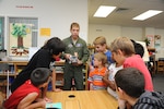 Lt. Col. Lex Cloutier, 99th Flying Training Squadron instructor pilot, demonstrates how robots work to fifth graders at Randolph Elementary School during a meeting of the school's robotics club Sept. 24. (U.S. Air Force photo by Don Lindsey)