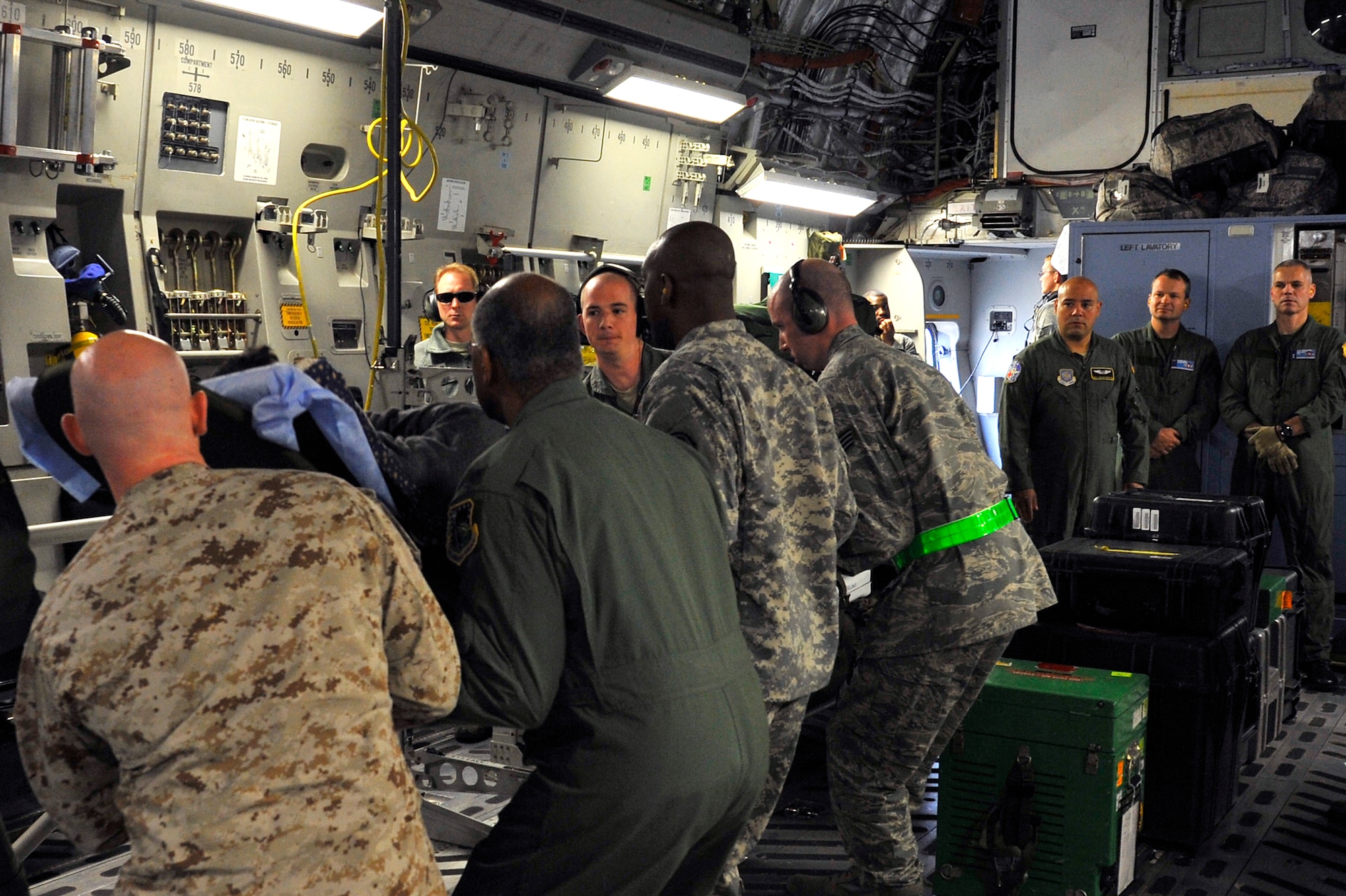 Flight medics move wounded warriors onto a C-17 Globemaster III, Ramstein Air Base, Germany, Jan. 25, 2012. The medical branch visited the Contingency Aeromedical Staging Facility, Landstuhl Regional Medical Center and other medical agencies to learn how the U.S. performs aeromedical evacuation and critical care aeromedical transport missions. (U.S. Air Force photo/Senior Airman Trevor Rhynes)
