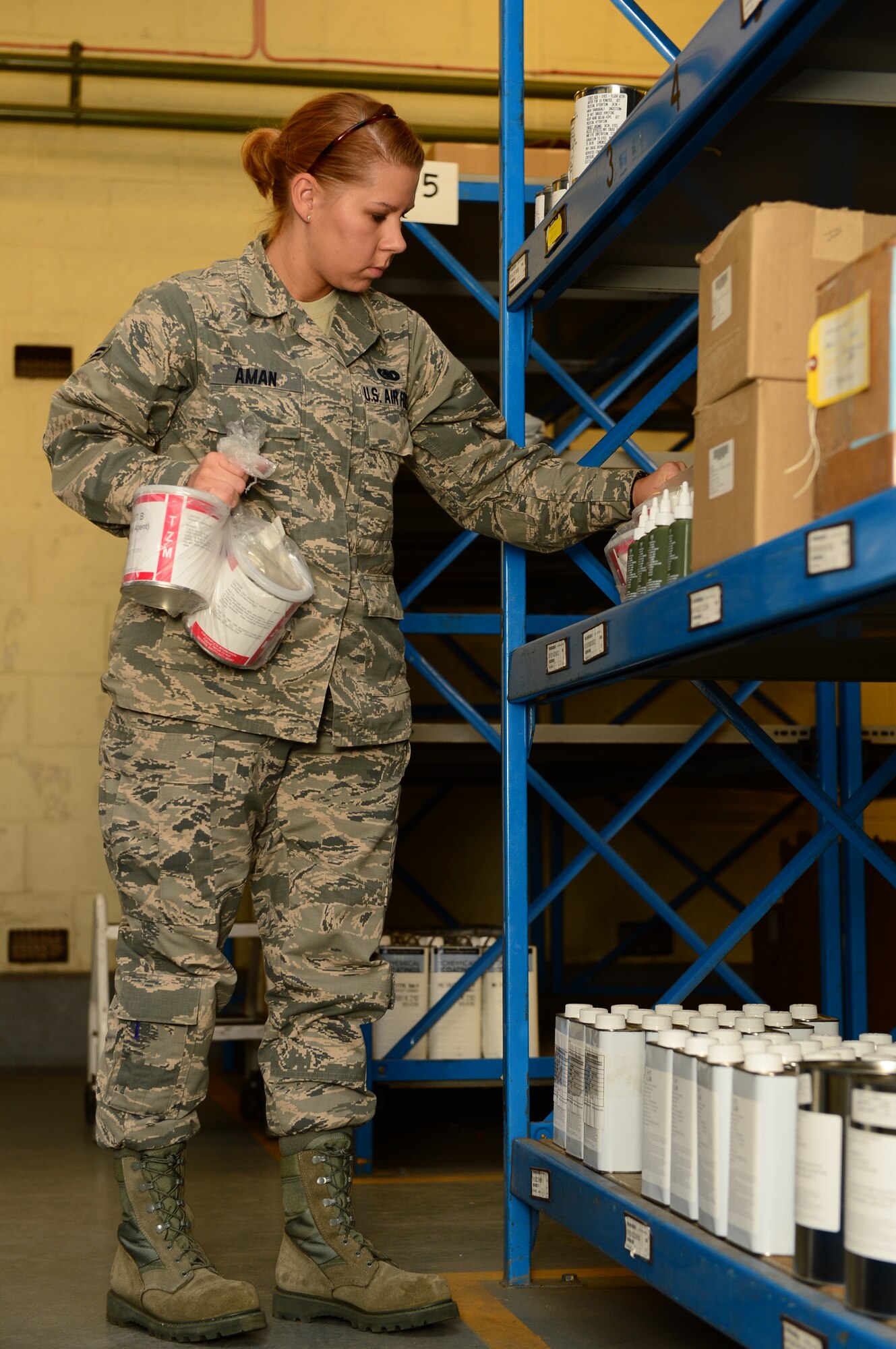 Airman 1st Class Brittney Aman, 48th Logistics Readiness Squadron hazardous materials pharmacy apprentice, pulls product from the shelf to complete an order at Royal Air Force Lakenheath, England, Oct. 3, 2013. The 48th LRS HAZMAT pharmacy is responsible for storing all hazardous materials for RAFs Lakenheath and Feltwell. (U.S. Air Force photo by Airman 1st Class Dawn M. Weber/Released) 