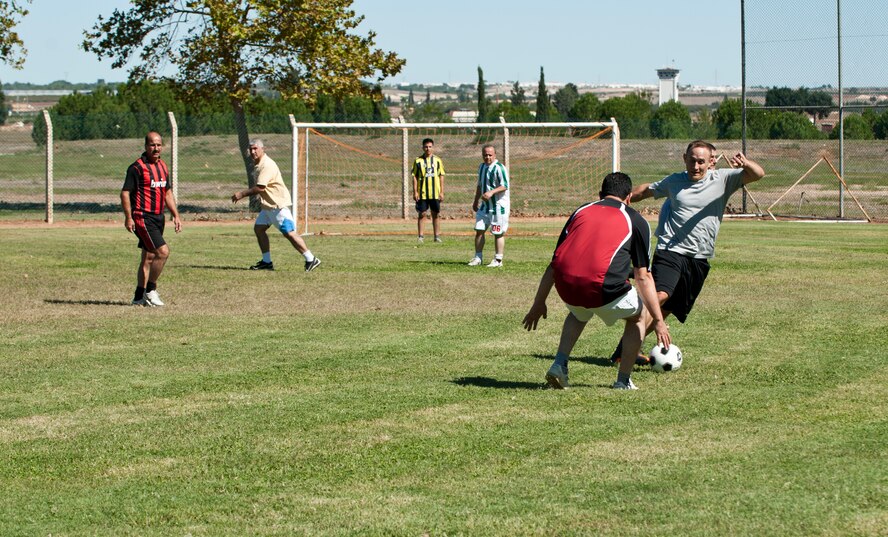 Rival teams duke it out for the ball to drive it into the opposing teams net during a 39th Logistic Readiness Squadron soccer game at Arkadas Park Oct. 7, 2013, at Incirlik Air Base, Turkey. The 39th LRS often holds events such as this soccer match to help strengthen the solidarity between the various nationalities on Incirlik AB. (U.S. Air Force photo by Senior Airman Daniel Phelps/Released)