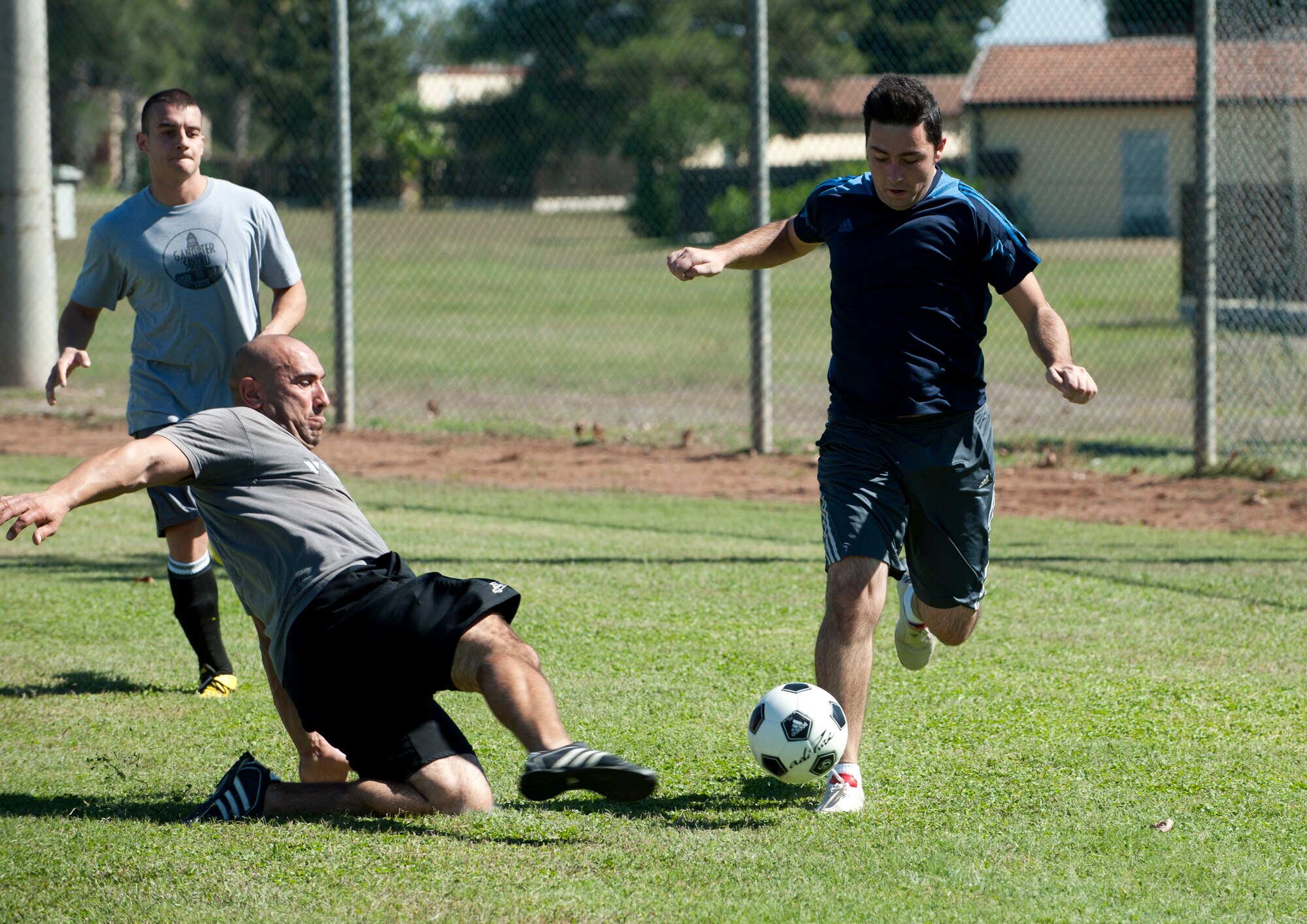 Athletes combat for the soccer ball during a 39th Logistics Readiness Squadron game at Arkadas Park Oct. 7, 2013, at Incirlik Air Base, Turkey. Soccer is one of the most popular sports in the world and is a common athletic factor between nationalities. (U.S. Air Force photo by Senior Airman Daniel Phelps/Released)