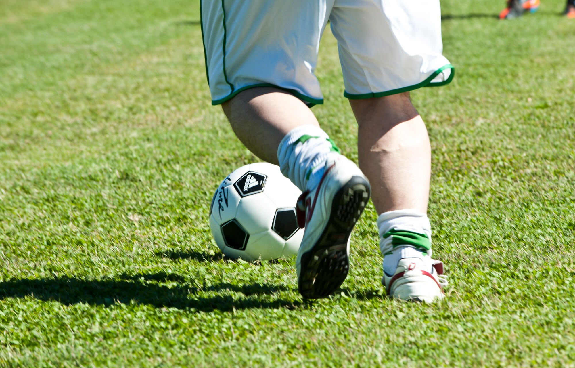 A soccer player dribbles the ball down the field during a 39th Logistics Readiness Squadron game at Arkadas Park Oct. 7, 2013, at Incirlik Air Base, Turkey. The 39th LRS often holds events to strengthen the cross-cultural partnership between their Turkish and American comrades. (U.S. Air Force photo/Senior Airman Daniel Phelps/Released)