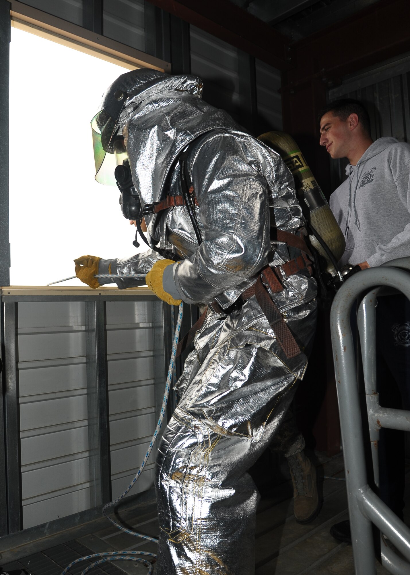 A participant in the Commanders vs. First Sergeants Fire Muster Competition Oct. 9 at the Fire Station pulls on a rope attached to a three-inch donut hose roll after ascend three flights of stairs. (U.S. Air Force Photo/Airman Daniel Lile)
