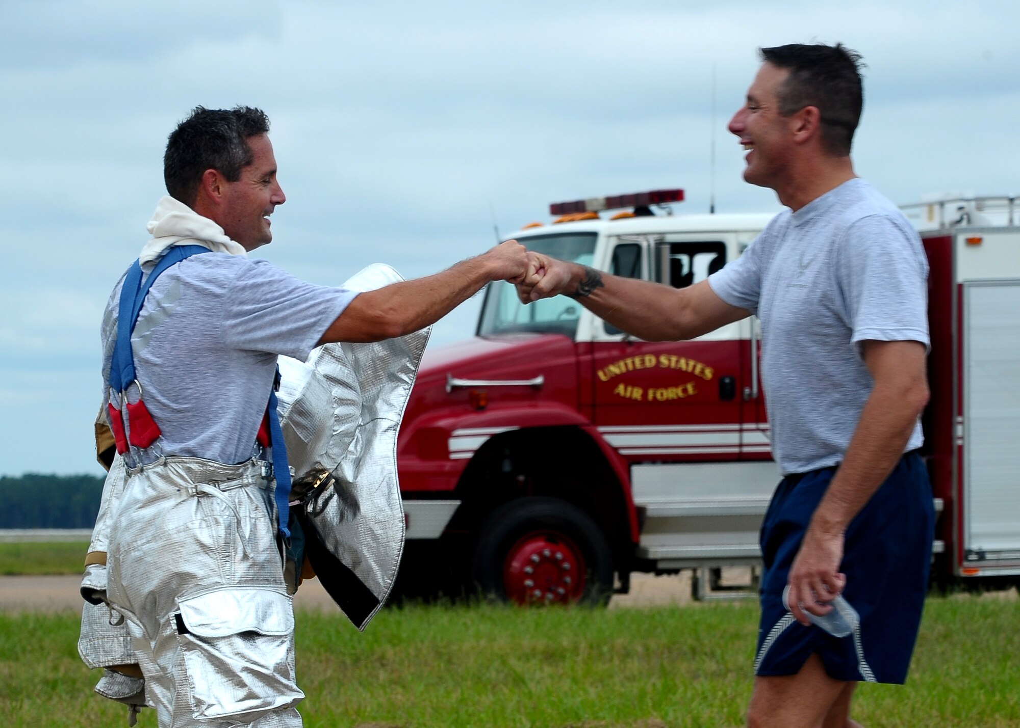 Maj. Ingemar Westphall, 14th Communications Squadron Commander, and Chief Master Sgt. Vance Kondon, 14th Flying Training Wing Command Chief, share a job well done “fistbump” after the Commanders vs. First Sergeants Fire Muster Competition Oct. 9 at the Fire Station. (U.S. Air Force Photo/Airman Daniel Lile)