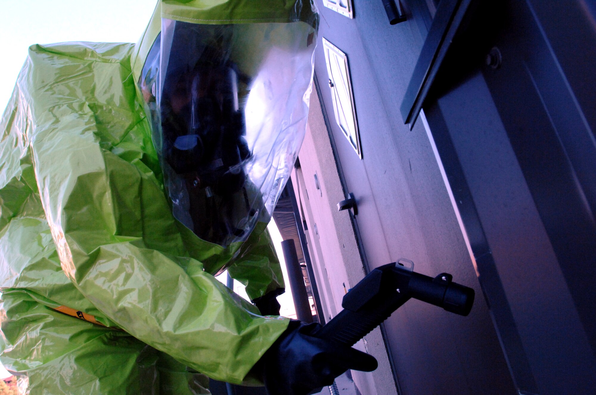Tech. Sgt. Jennifer Kingsley, 319th Medical Operations Squadron Bioenvironmental Flight NCO in charge, checks for chemical residue outside a building where a simulated hazardous materials (HAZMAT) pharmacy fire took place. Teams of two, consisting of an emergency manager and a bioenvironmental engineer, suited up in HAZMAT gear and entered the “contaminated” area, looking for spills and other chemical hot spots, and radioed back to the incident command post with their findings. (U.S. Air Force photo/Staff Sgt. Susan L. Davis)