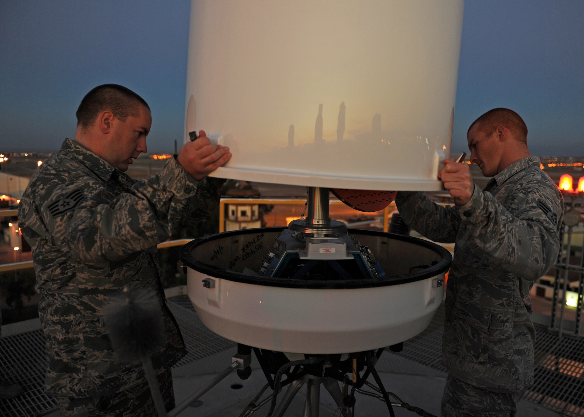 Staff Sgt. Eric Vincent and Senior Airman Abel Crow, 39th CS ground radar systems technicians, remove the dome from the Portable Doppler Radar Oct. 10, 2013, at Incirlik Air Base, Turkey. The weather radar, which sits on top of a 100 foot tower, was opened for troubleshooting. (U.S. Air Force photo/Senior Airman Chase Hedrick)