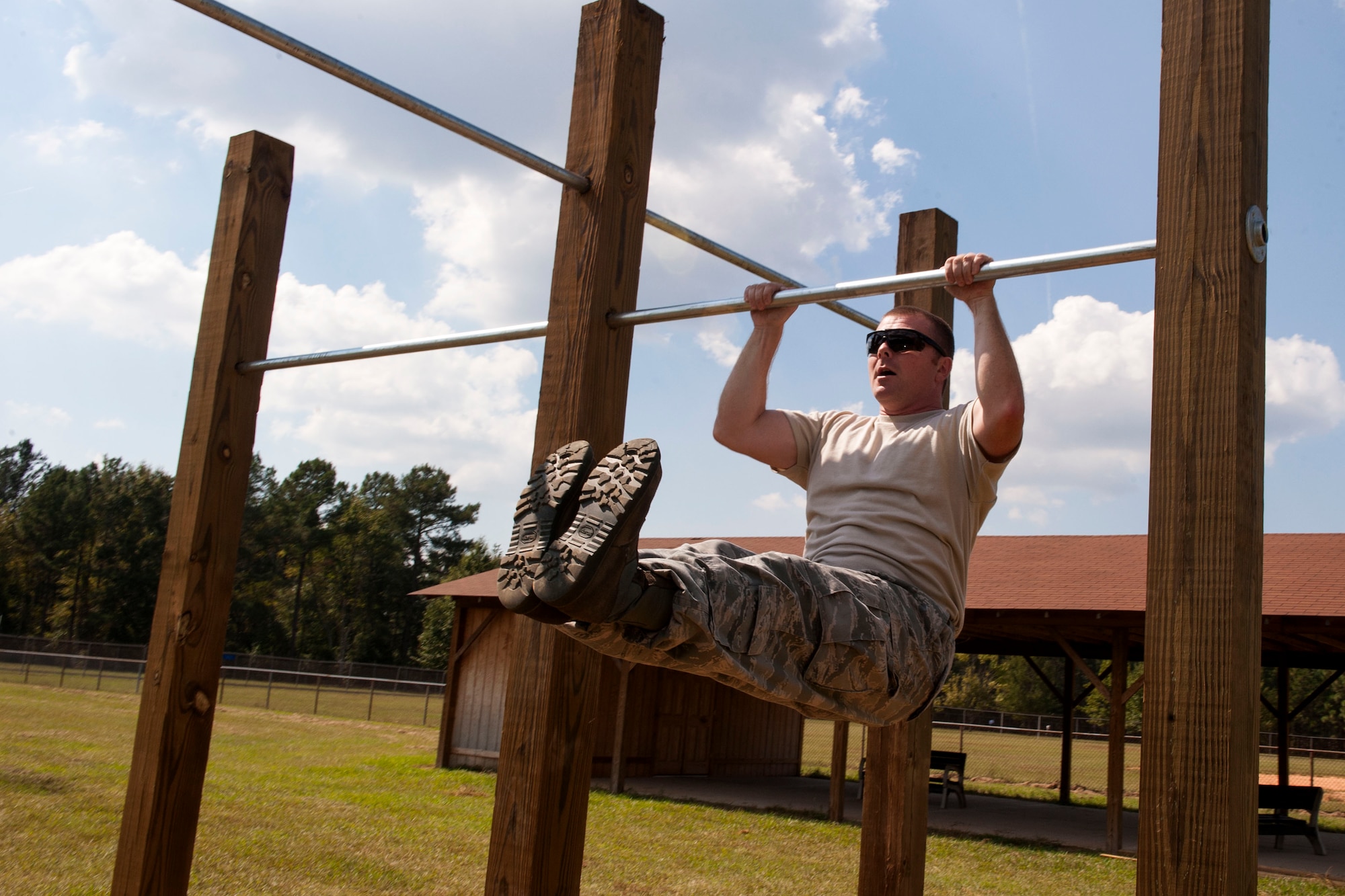 U.S. Air Force Tech. Sgt. Jason Dees, a crew chief with the 169th Aircraft Maintenance Squadron, performs a pull up on the newly constructed bars on McEntire Joint National Guard Base, S.C., Oct. 5, 2013. The new pull bars were built by Boy Scouts from troop 95 from Irmo, S.C. (U.S. Air National Guard photo by Staff Sgt. Jorge Intriago/Released) 