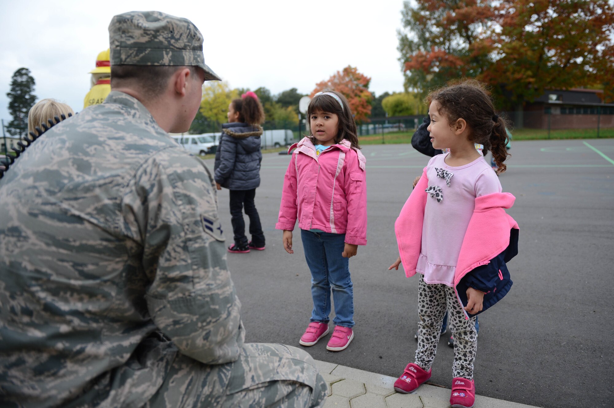 SPANGDAHLEM AIR BASE, Germany – U.S. Air Force Airman 1st Class Jason Seavey, 52nd Civil Engineer Squadron fire protection technician from Baileyville Maine, talks to children from the School Age Program about making safe decisions that can help prevent fires Oct. 9, 2013. The visit to the SAP was part of fire prevention week which originally began in 1922 in efforts to increase fire safety and awareness. (U.S. Air Force photo by Airman 1st Class Kyle Gese/Released)
