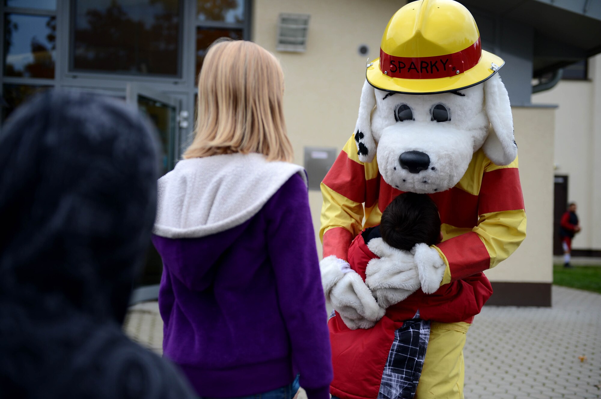 SPANGDAHLEM AIR BASE, Germany – Children from the School Age Program anxiously stand in line to give Sparky the Fire Dog a hug Oct. 9, 2013. Sparky met with children to increase fire safety awareness during fire prevention week. (U.S. Air Force photo by Airman 1st Class Kyle Gese/Released)