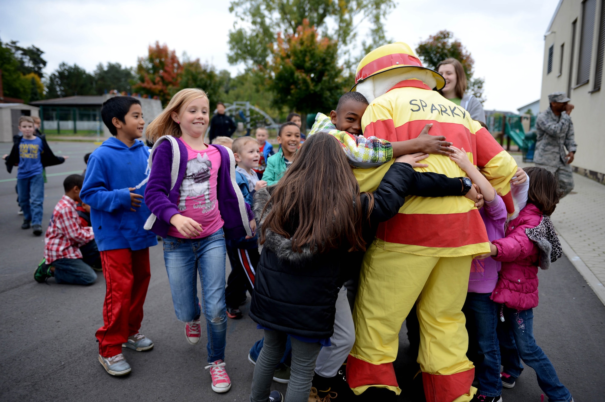 SPANGDAHLEM AIR BASE, Germany – Children from the School Age Program rush to meet Sparky the Fire Dog as part of fire prevention week Oct. 9, 2013. Sparky and his fire fighting companions reminded children to be safe and that fire fighters are their friends. (U.S. Air Force photo by Airman 1st Class Kyle Gese/Released)
