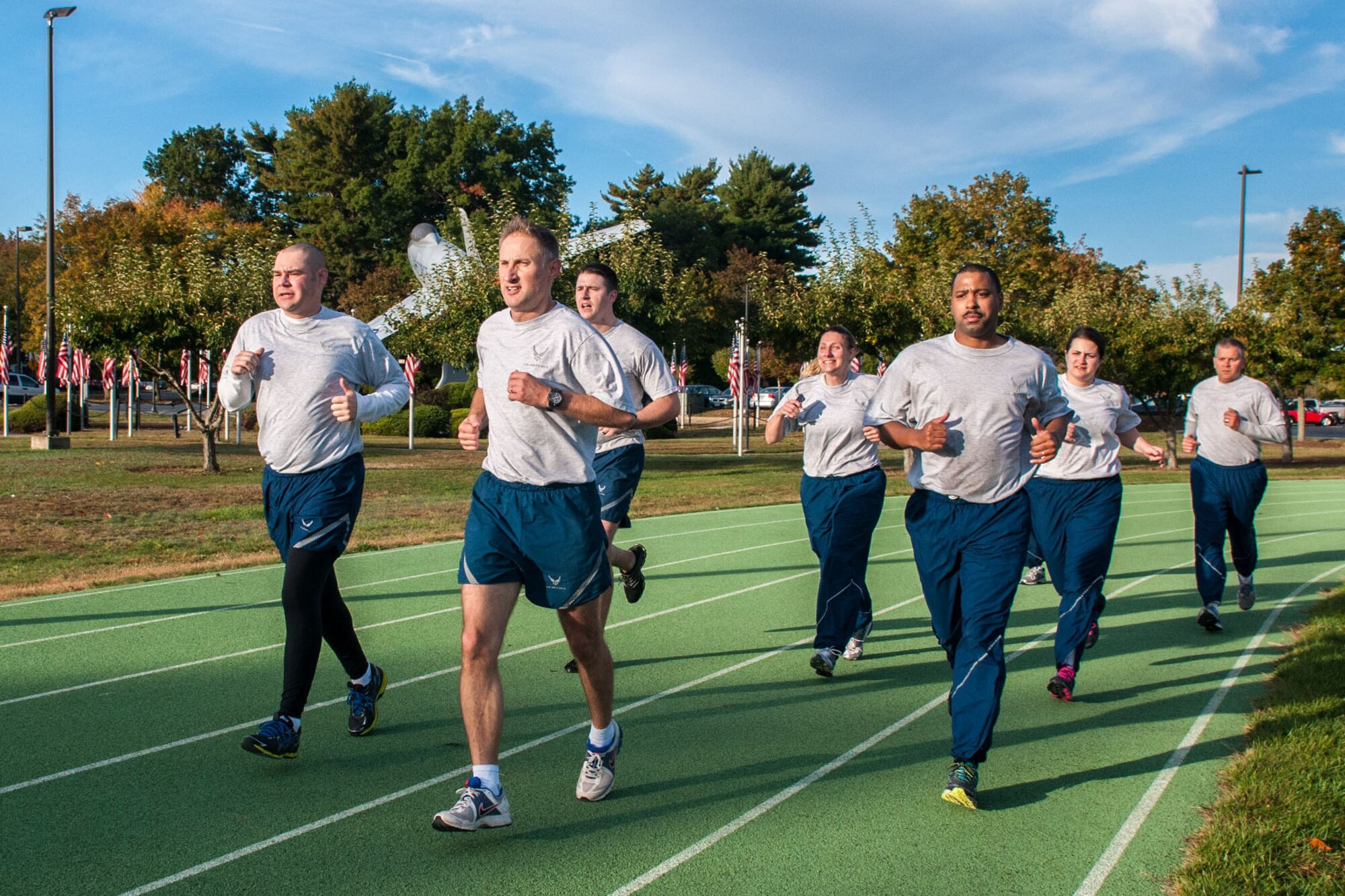 HANSCOM AIR FORCE BASE, Mass. – Led by Lt. Col. Anthony Stroup (center), members of the 319th Recruiting Squadron keep pace Oct. 9 on the base running track as they train for the Air Force physical fitness assessment. A new winter fitness assessment schedule begins Nov. 4. Assessments will take place Monday through Thursday at 10 a.m., 11 a.m., as well as noon, with six testing slots available per session. (U.S. Air Force photo by Rick Berry)