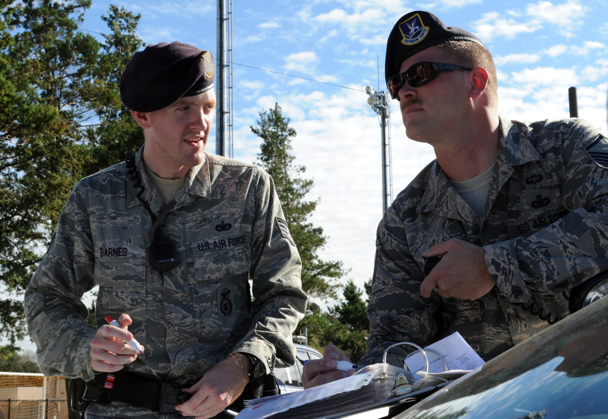 Right, Staff Sgt. Barnes and Master Sgt. Theodore Fest, 374th Security Forces Squadron, establish a cordon during an emergency management exercise Oct. 10, 2013, at Yokota Air Base, Japan. First responders tested their emergency management skills as part of Readiness Week. (U.S. Air Force photo by Senior Airman Desiree Economides/Released)