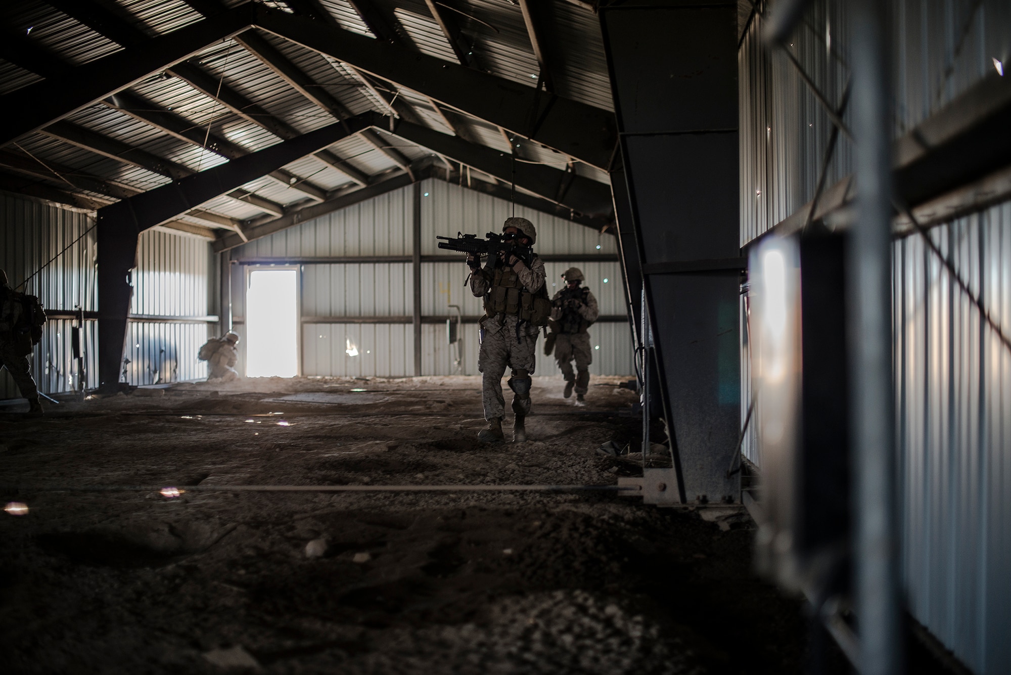 U.S. Marine joint terminal attack controllers, forward air controllers and radio operators from the 1st Air Naval Gunfire Liaison Company Supporting Arms Liaison Team Delta, from Camp Pendleton, Calif., clear an enemy compound as they search for chemical weapons, during exercise Mountain Roundup 2013 at Juniper Butte Range, about 70 miles from Mountain Home Air Force Base, Idaho, Oct. 8, 2013. JTACs can change the course of any firefight or any enemy worldwide in a defensive posture by deterring the enemy from firing on friendly forces, or can go kinetic and make sure those insurgents will never fire on a friendly soldier again.  (U.S. Air Force photo by Master Sgt. Kevin Wallace/RELEASED)