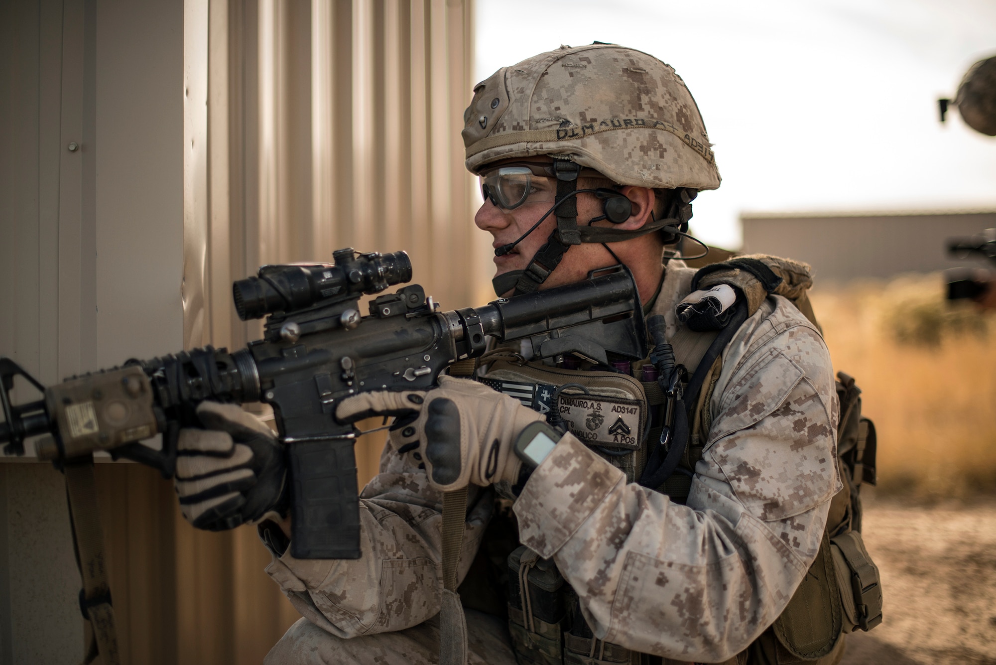 U.S. Marine Cpl. Andrew Dimauro, 1st Air Naval Gunfire Liaison Company forward air controller deployed from Camp Pendleton, Calif., scans a sector of fire and anticipates enemy contact during an exercise urban combat scenario during exercise Mountain Roundup 2013 at Juniper Butte Range, about 70 miles from Mountain Home Air Force Base, Idaho, Oct. 8, 2013. In Dimauro’s exercise scenario, he attached to a U.S. Army unit and assault through the objective looking for chemical weapons - Serine gas - near the rail yard. Dimauro also assisted the U.S. Air Force’s 366th Fighter Wing Public Affairs office by wearing one of their helmet cameras, to capture video footage during the exercise. (U.S. Air Force photo by Master Sgt. Kevin Wallace/RELEASED)