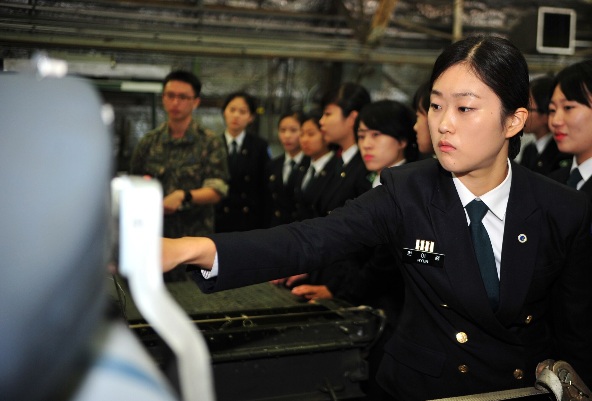 A Republic of Korea army Reserve Officers’ Training Corps cadet from Sungshin University inspects an inert training bomb during a tour of Osan Air Base, ROK, Oct. 9, 2013. Many cadets said their favorite part of the tour was the ability to see and touch static displays of Osan’s aircraft. (U.S. Air Force photo/Airman 1st Class Ashley J. Thum) 