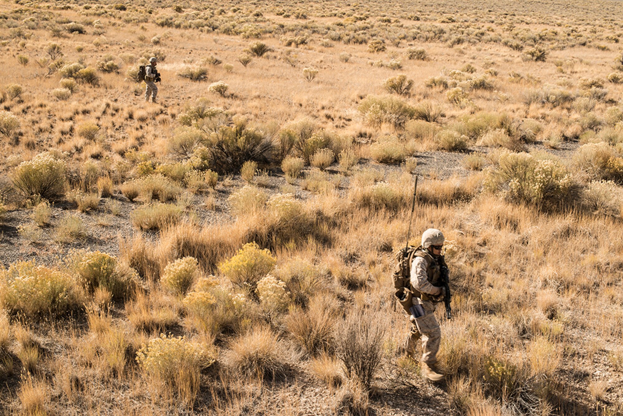 U.S. Marine joint terminal attack controllers, forward air controllers and radio operators from the 1st Air Naval Gunfire Liaison Company Supporting Arms Liaison Team Delta, from Camp Pendleton, Calif., move across a field as they prepare to assault an exercise enemy during exercise Mountain Roundup 2013 at Juniper Butte Range, about 70 miles from Mountain Home Air Force Base, Idaho, Oct. 8, 2013. JTACs can change the course of any firefight or any enemy worldwide in a defensive posture by deterring the enemy from firing on friendly forces, or can go kinetic and make sure those insurgents will never fire on a friendly soldier again.  (U.S. Air Force photo by Master Sgt. Kevin Wallace/RELEASED)