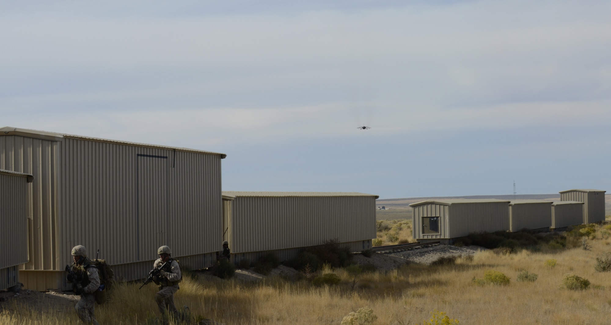 U.S. Marine Cpl. Daniel Soto, 1st Air Naval Gunfire Liaison Company forward air controller, and Cpl. Avila Sison, 1st ANGLICO forward observer, run to cover during Mountain Roundup 2013 Urban Operations training Oct 8, 2013, at the Juniper Butte range. Mountain Roundup is part of GAF Tornado Fighter Weapons Instructor Course Mission Employment Phase, where everyone involved works to provide proficient integrated combined joint forces. (U.S. Air Force photo by Senior Airman Benjamin Sutton/RELEASED)