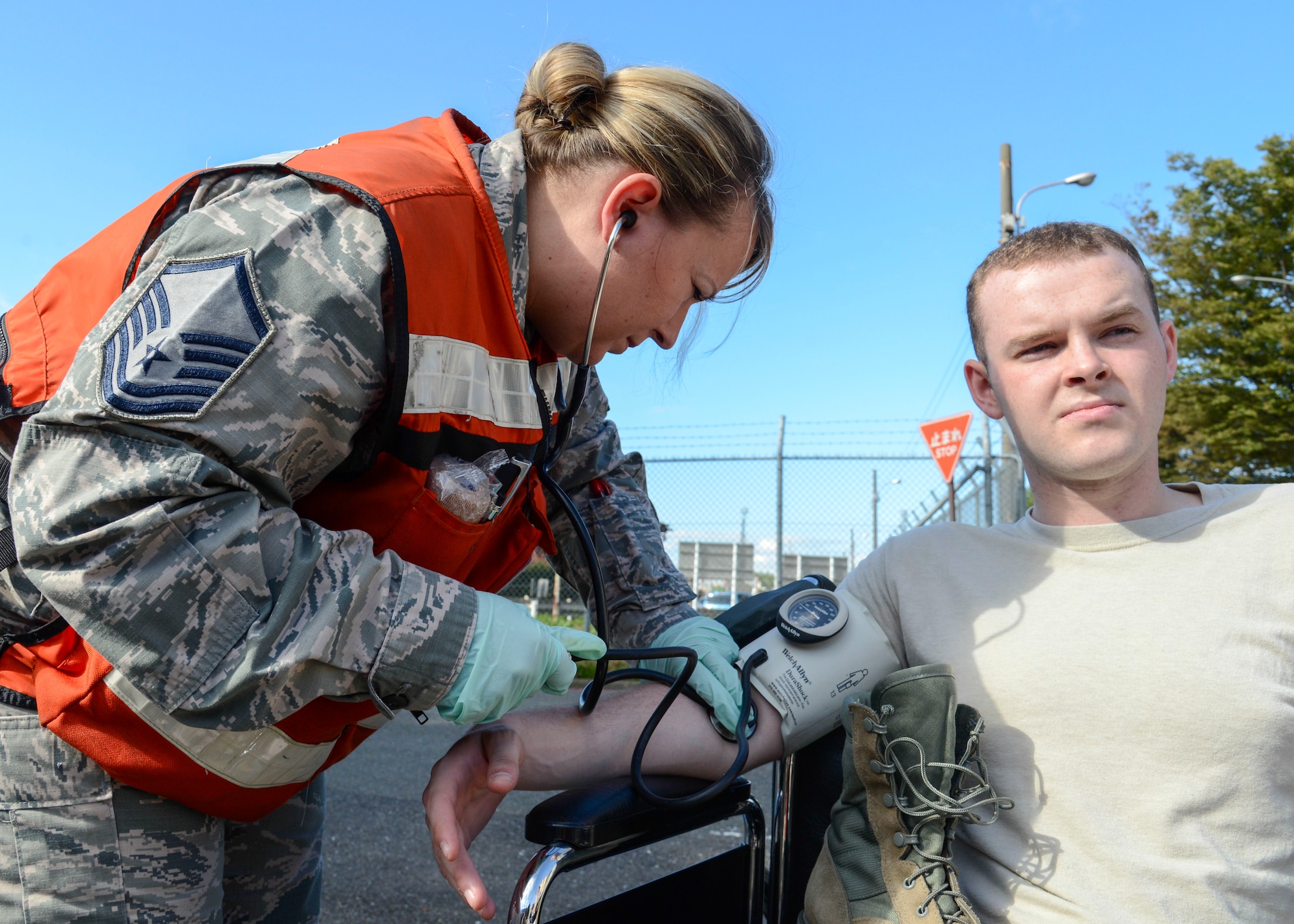 Master Sgt. Candace Stacy, a medical technician with the 374th Medical Group, checks the blood pressure of an Airman with a simulated injury during an emergency management exercise during Readiness Week at Yokota Air Base, Japan, Oct. 10, 2013.  The exercise provided an opportunity for the members of 374th MDG to hone their life-saving skills.  (U.S. Air Force photo by Airman 1st Class Soo C. Kim/Released)