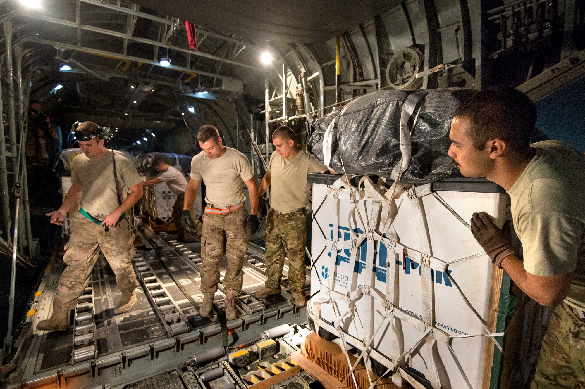 Loadmasters and crew chiefs from the 774th Expeditionary Airlift Squadron load cargo bundles on a C-130H Hercules destined for a remote drop zone in Ghazni province, Afghanistan, Oct. 6, 2013 at Bagram Air Field, Parwan Province, Afghanistan. (USAF Photo/Master Sgt. Ben Bloker)