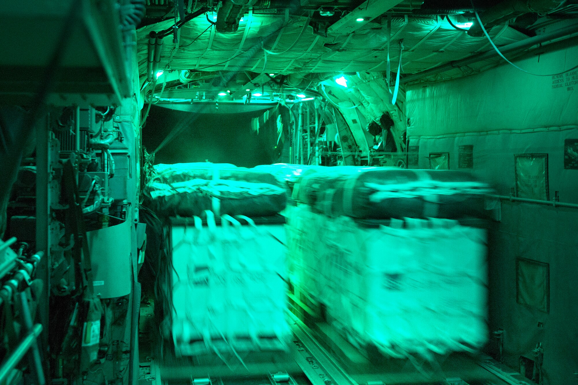 Sixteen cargo bundles roll out the ramp of a 774th Expeditionary Airlift Squadron C-130H Hercules over a remote drop zone in Ghazni province, Afghanistan, Oct. 7, 2013. (USAF Photo/Master Sgt. Ben Bloker)