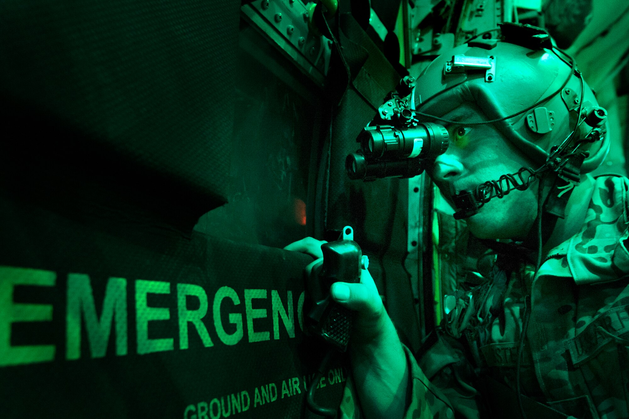 Senior Airman Larry Webster, 774th Expeditionary Airlift Squadron loadmaster, scans for potential threats using night vision goggles after completing a cargo airdrop in Ghazni province, Afghanistan, Oct. 7, 2013. Webster, a Lyons, Colo., native, is deployed from Little Rock Air Force Base, Ark. (USAF Photo/Master Sgt. Ben Bloker)