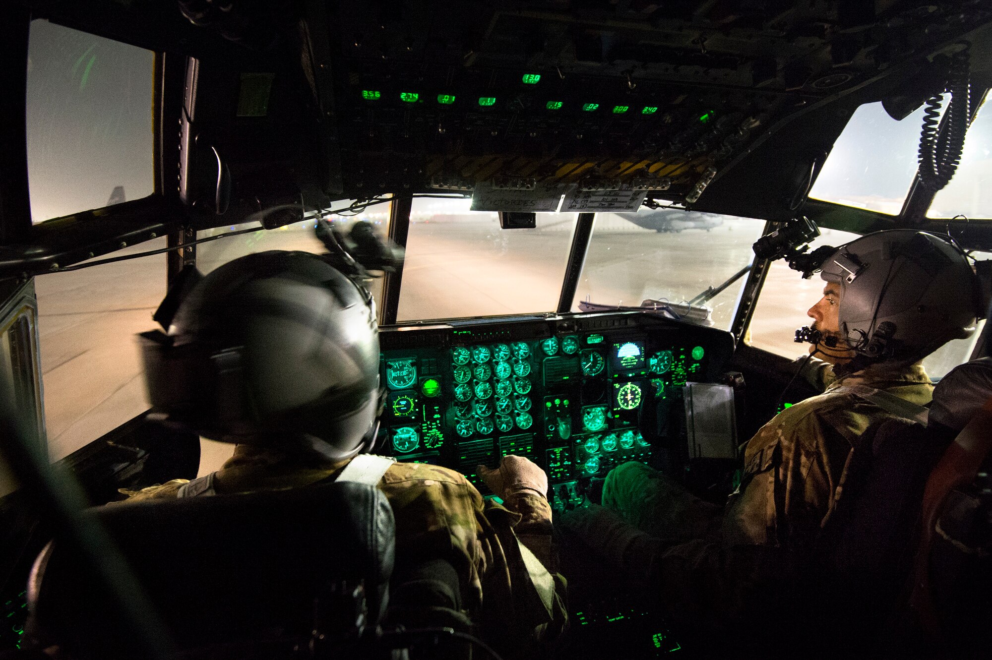 Maj. Kurt Wampole, assisted by Capt. Matt Ward, 774th Expeditionary Airlift Squadron pilots, taxis a C-130H Hercules back to its parking spot at Bagram Air Field, Parwan province, Afghanistan, Oct. 7, 2013 after completing an air cargo drop mission in Ghazni province, Afghanistan. Wampole, a Rialto, Calif. native, and Ward, a Wellsville, N.Y. native, are deployed from Little Rock Air Force Base, Ark. (USAF Photo/Master Sgt. Ben Bloker)