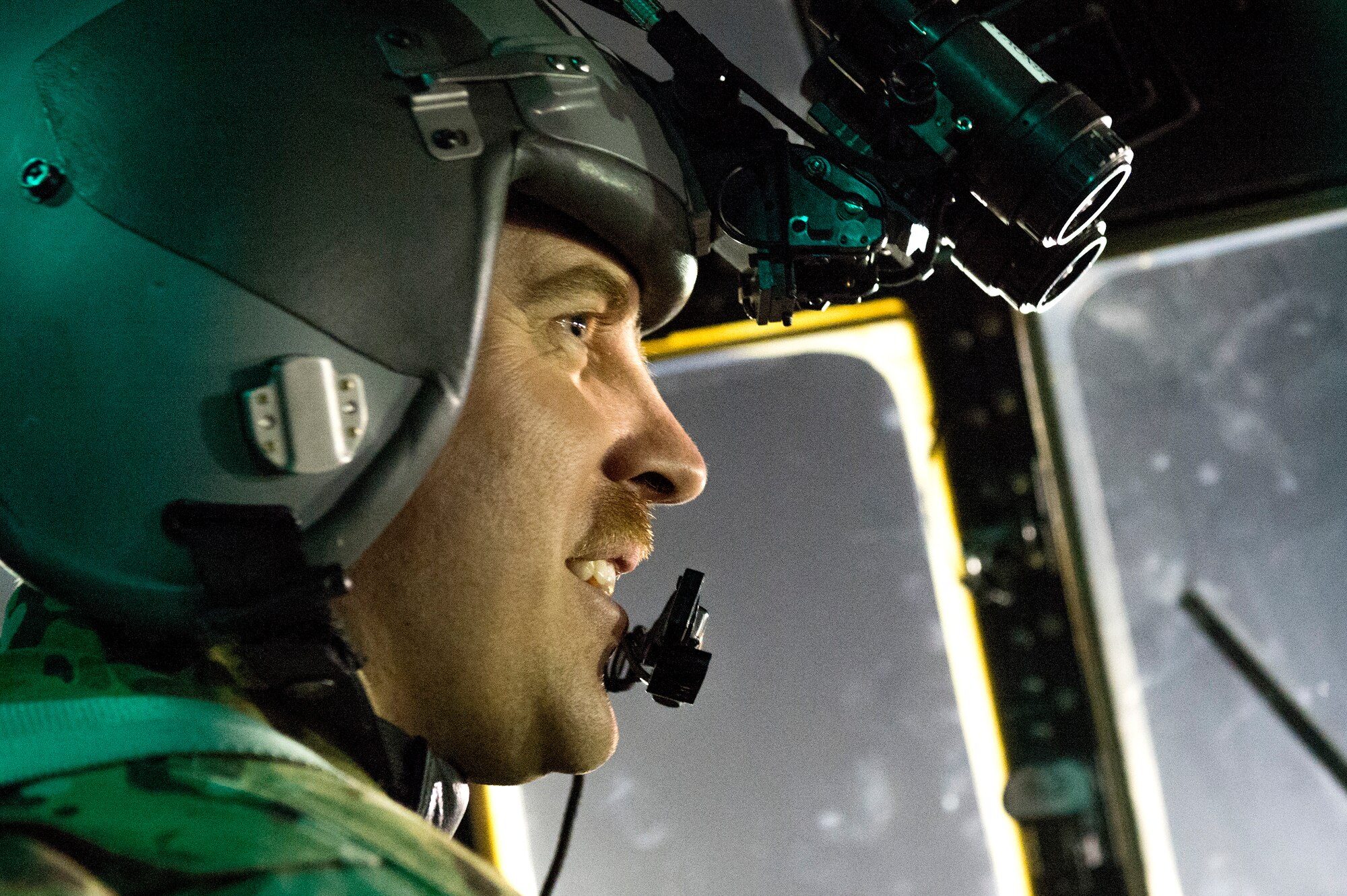 Maj. Kurt Wampole, 774th Expeditionary Airlift Squadron pilot, reacts after his crew successfully completed a pair of late night aerial cargo drops aboard a C-130H Hercules at Bagram Air Field, Parwan province, Afghanistan, Oct. 7, 2013. The crew delivered 32 cargo bundles during two trips to remote drop zones in Ghazni province, Afghanistan. Wampole, a Rialto, Calif., native, is deployed from Little Rock Air Force Base, Ark. (USAF Photo/Master Sgt. Ben Bloker)