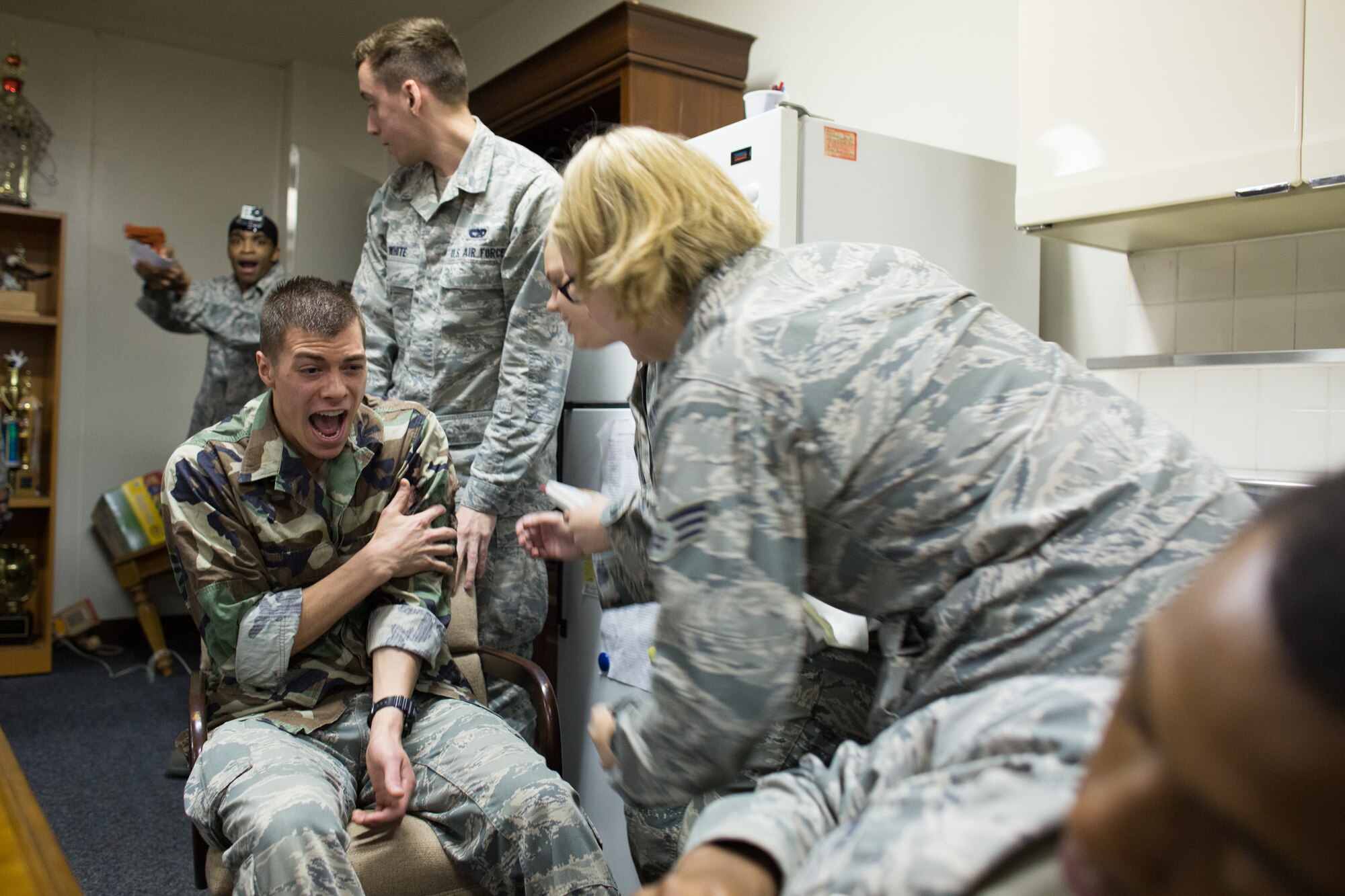 Airmen from the 374th Logistics Readiness Squadron perform self-aid and buddy care to a simulated injured victim during an active shooter scenario at Yokota Air Base, Japan, Oct. 10, 2013. The scenario allowed installation security forces to practice their skills during an active shooter scenario, and was conducted as part of wing-wide training during Readiness week, which focus on enhancing the wing's ability to conduct its airlift mission under various conditions. (U.S. Air Force photo by Osakabe Yasuo/Released)
