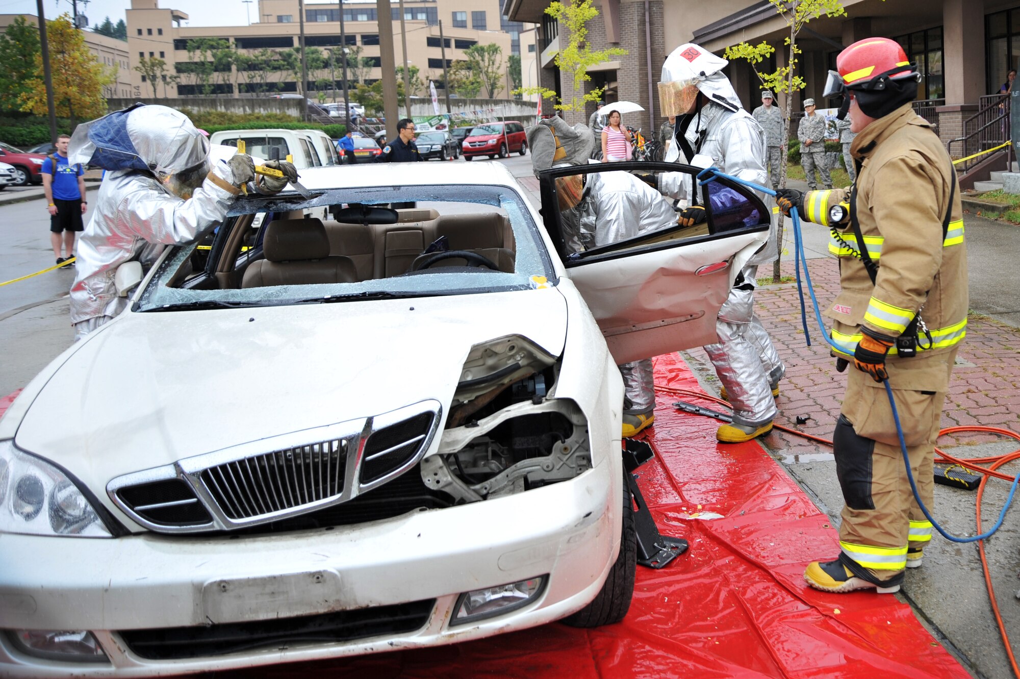 Members of the 51st Civil Engineer Squadron fire and emergency services showcase how they would dismantle a vehicle if they needed to remove personnel during a vehicle extrication demonstration at Osan Air Base, Republic of Korea, Oct. 8, 2013. The demonstration was held to showcase how firefighters tear a vehicle away from a person in an accident. (U.S. Air Force photo/Staff Sgt. Emerson Nuñez)