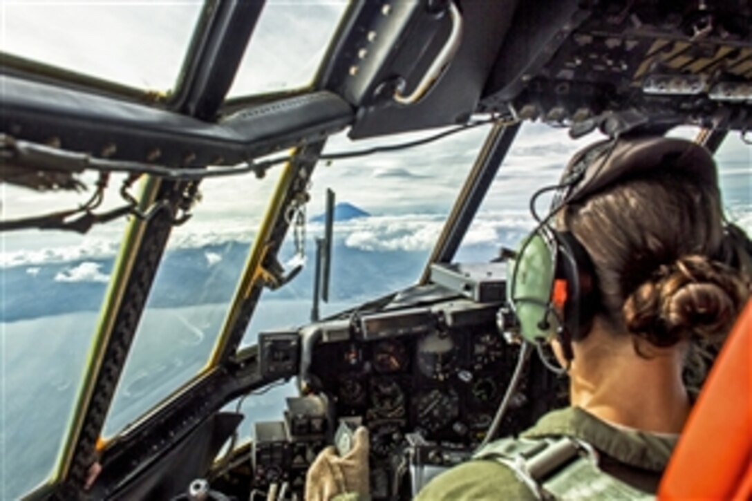 U.S. Air Force Capt. Taylor Rigollet pilots a C-130 Hercules aircraft over Sagami Bay, Japan, Oct. 8, 2013, during readiness week. Rigollet, a pilot, is assigned to the 36th Airlift Squadron.