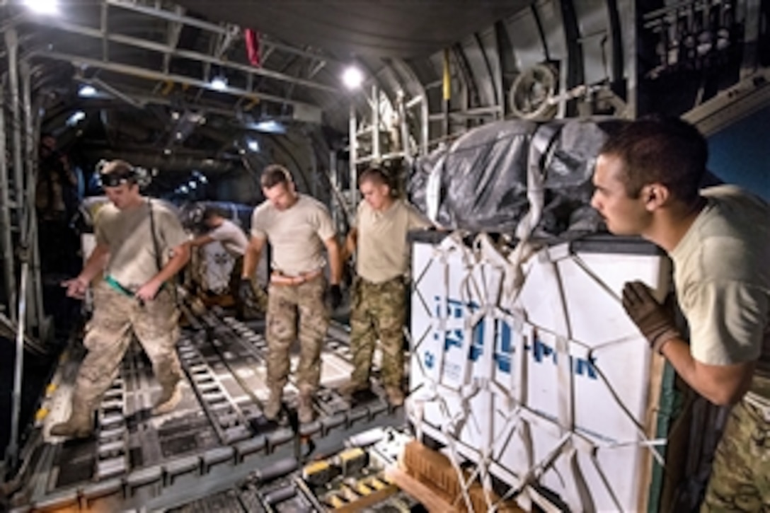 U.S. Air Force personnel load cargo bundles, destined for a remote drop zone in Ghazni province, on a C-130H Hercules aircraft on Bagram Airfield in Afghanistan's Parwan province, Oct. 6, 2013. The airmen, crew chiefs and loadmasters are assigned to the 774th Expeditionary Airlift Squadron.