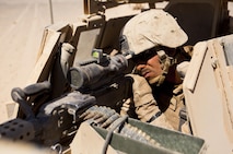 Lance Cpl. Kevin Dunseith, a Blue Point, N.Y., native and turret gunner with Combat Logistics Regiment 2, Regional Command (Southwest), crews his machine gun during a combat logistics patrol in Helmand province, Afghanistan, Oct. 1, 2013. Dunseith stood in the turret for hours watching for possible threats during a four-day mission to Camp Dwyer, Afghanistan.