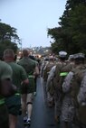 Marines and sailors with Combat Logistics Battalion 2, Combat Logistics Regiment 2, 2nd Marine Logistics Group (right) conduct a conditioning hike while service members with Combat Logistics Regiment 25, 2nd MLG (left) run past them aboard Camp Lejeune, N.C., Oct. 10, 2013. The battalion’s command organized the hike to build camaraderie and motivation among the unit’s service members. 