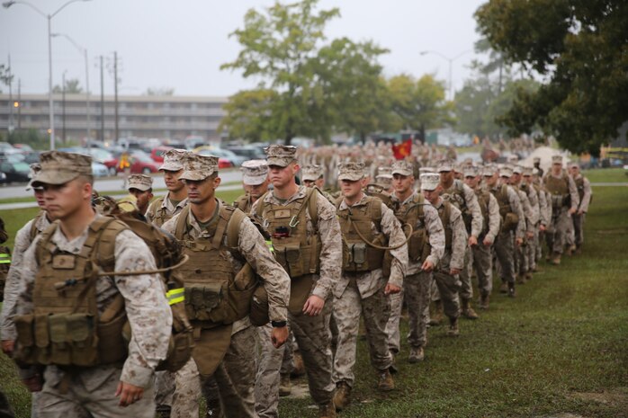 Marines and sailors with Combat Logistics Battalion 2, Combat Logistics Regiment 2, 2nd Marine Logistics Group march to the end of a battalion hike aboard Camp Lejeune, N.C., Oct. 10, 2013. The battalion completed the approximately 3.8-mile, hour-long conditioning hike in the rain alongside Combat Logistics Regiment 25’s regimental run.