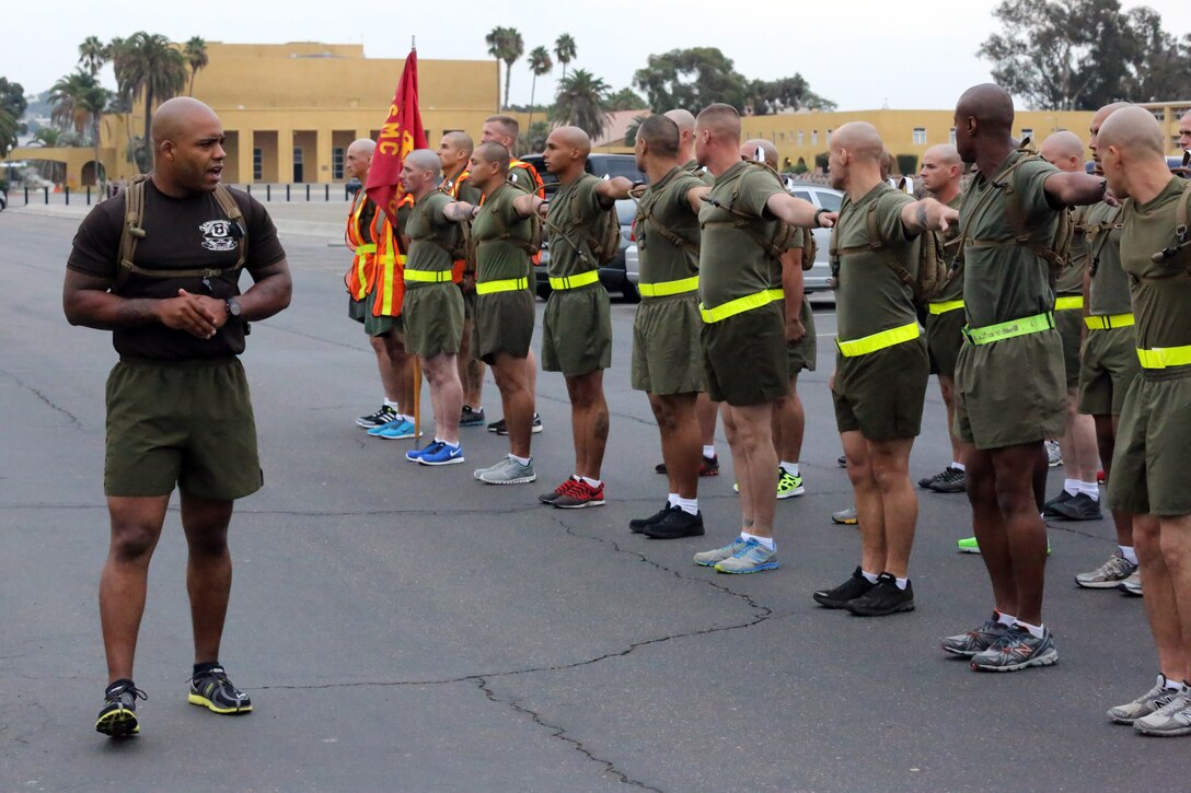 Staff Sgt. Michael D. Riggs, physical training instructor, Drill Instructor School, gives the command dress-right-dress to align the platoon before their Initial Physical Fitness Test aboard the depot, Oct. 1. Drill movements are an important tool in the drill instructor arsenal as they instill instant obedience to orders.