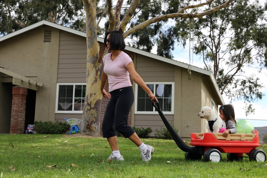 Ayako Hansen plays with her daughter, Lia, and their dog, Shi-sa, in O'Neill Heights Housing where their family were finally able to return after being evacuated, Oct. 5, for a fire that reached 2,500 acres. Lia is 2 years old.

